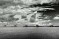 Five drop net fishing huts in Marina di Pisa, Tuscany, Italy, under a dramatic sky, in black and white