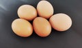 Five eggs on the black background. Eggs for ingridient to