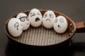 Five eggs with painted emotions in a frying pan, a food concept Royalty Free Stock Photo