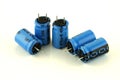Five electrolytic capacitors in blue Royalty Free Stock Photo