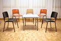 five empty chairs around a square laminate table Royalty Free Stock Photo