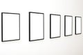 Five empty frames on white wall exhibition