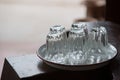 five empty glasses put upside down on white tray on wood table w Royalty Free Stock Photo