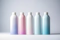 Five empty plastic cosmetics bottles pastel colors on white background