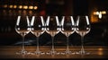 Five empty wine glasses with ligts behind on bar table, Ai Generated
