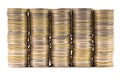 Five equal stacks of coins merged in one wall isolated on white background. Symbol of annuity or flat level.
