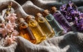 Five Essential Oil Bottles on Linen Fabric with Flowers Royalty Free Stock Photo