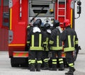 five firefighters with uniform and the fire truck during emergen