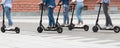 Five friends having ride on motorized kick scooters Royalty Free Stock Photo