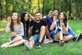 Five friends women and men inflate soap bubble outdoors Royalty Free Stock Photo