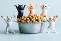 Five funny toy kittens next to a bowl filled with dry cat food. The concept of food for pets