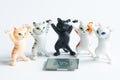 Five funny toy kittens with raised paws next to a modern powerful computer processor on a white background. Computer assembly. Royalty Free Stock Photo