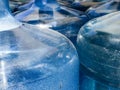 Five 5 gallon water bottles full and empty blue plastic dry and condensation Royalty Free Stock Photo