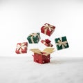 Five gift boxes float above a snowy surface , gifts background on white Royalty Free Stock Photo