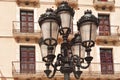 Vintage metal lantern on background typical building facade with balconies in Tarragona, Spain