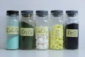 Glass jars with different inorganic chemicals with stickers and formulas.