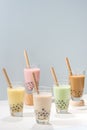 Five glasses of healthy milky boba or bubble tea flavored with fresh fruit and chocolate and served with traditional wide straws Royalty Free Stock Photo