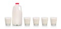Five glasses of milk by plastic bottle on white