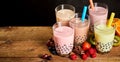 Five glasses of milky bubble tea with fresh fruit