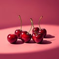 Five glossy cherries with long, slender stems are placed on a smooth pink surface. The Royalty Free Stock Photo