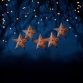 Five Glowing Star-Shaped Paper Lanterns Hanging on a Tree With Fairy Lights in the Background Royalty Free Stock Photo