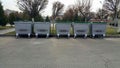 Five gray trash bins installed in the city for various types of materials. Zero waste. Containers for metal, glass, plastic, e