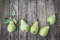 Five green pears on old wooden table, high angle view Royalty Free Stock Photo