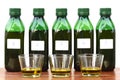 Five green plastic bottles stand next to each other and are filled with liquid. There is a number on every bottle. In front of it Royalty Free Stock Photo