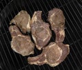 Five half-roasted pork chops on a gas grill Royalty Free Stock Photo