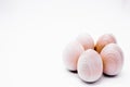 Five hand-made unpainted wooden eggs on a white background