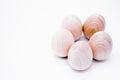 Five hand-made unpainted wooden eggs on a white background