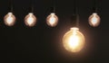 five hanging light bulb on black background. energy