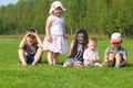 Five happy children on green grass on summer field Royalty Free Stock Photo