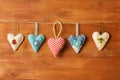 Five hearts made of cloth on wood background