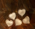 Five hearts made of ice on a dark wooden background