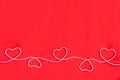 Five hearts made of white rope on red background, top view with space for text Royalty Free Stock Photo