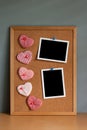 Five hearts shaped with two blank instant photos mounted on a corkboard, Valentines day concept Royalty Free Stock Photo