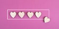 Five hearts on a ÃÂ¼ink colored background, hand put the last heart in the row, rating, giving feedback, business evalua