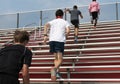 Boys running up bleachers at summer camp