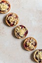 Five home baked plum crumble tarts in diagonal shape
