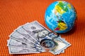 Five Hundred American Dollars, Compass, Globe of Planet Earth on a Fabric Background Closeup. Travel, tourism, adventures Concept Royalty Free Stock Photo