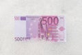 Five hundred euro banknote flat lay on white snow background Royalty Free Stock Photo