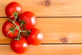 Five Hydroponic tomatoes over plain wooden table