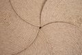 Five jute rope placemats arranged in a star shape, abstract texture backdrop Royalty Free Stock Photo