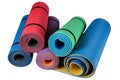 Five karemats or mats for fitness, different colors, lie in a pile, on a white background
