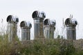 five large aluminum chimneys