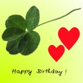 Five-leaf clover with two red hearts and Happy Birthday on lime green Royalty Free Stock Photo