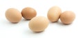 Five light brown chicken eggs.