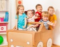 Five little drivers playing with cardboard car Royalty Free Stock Photo