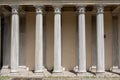 Five Marble Columns Against a Yellow Concrete Wall Royalty Free Stock Photo